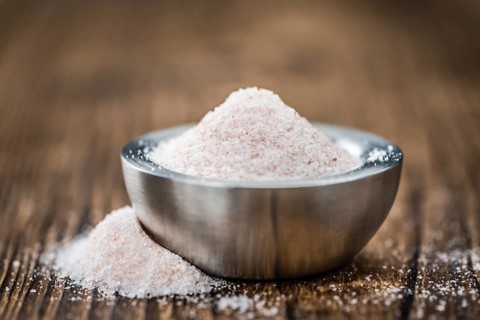 Himalayan Salt as high detailed close-up shot on a vintage wooden table (selective focus)