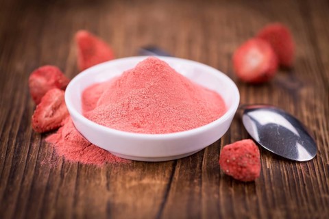Fresh made Strawberry powder on a vintage background as detailed close-up shot