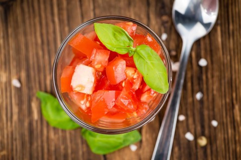 Diced Tomatoes on a vintage background as detailed close-up shot (selective focus)