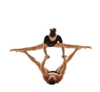 Paired acrobatics. Man and woman doing gymnastic splits in support