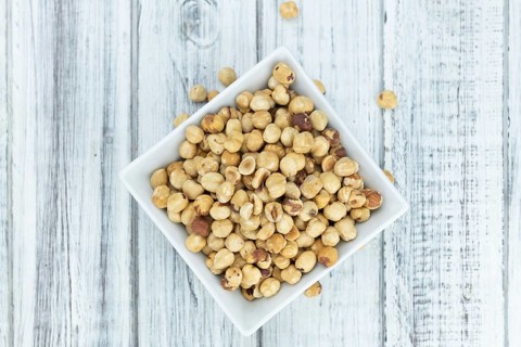 Peeled Hazelnuts as detailed close up shot (selective focus)
