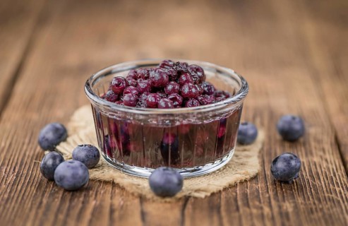 Preserved Blueberries on a vintage background as detailed close-up shot, selective focus