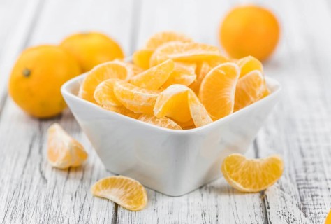 Raw Tangerine pieces (close-up shot) on vintage background