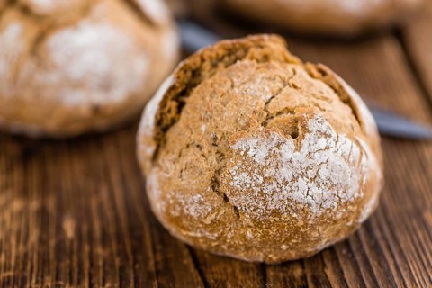 Wholemeal Roll on a vintage background as detailed close-up shot (selective focus)