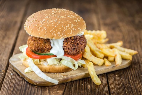 Homemade Falafel Burger (detailed close-up shot, selective focus) on a wooden table