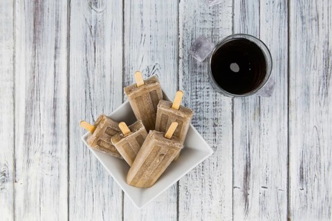 Some homemade Cola Popsicles (close-up shot, selective focus) on vintage background