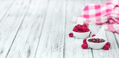 Fresh made Raspberry Jam on a vintage background as detailed close-up shot