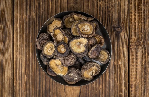 Dried Shiitake on a vintage background as detailed close-up shot, selective focus