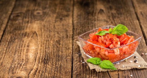 Diced Tomatoes on a vintage background as detailed close-up shot (selective focus)