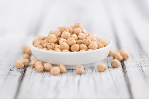 Chickpeas on a vintage background as detailed close-up shot, selective focus