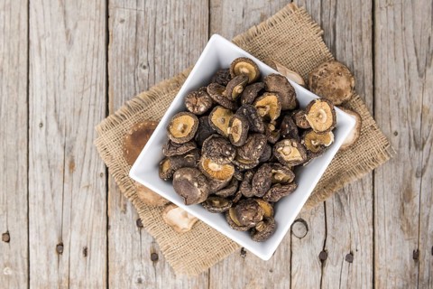 Dried Shiitake on a vintage background as detailed close-up shot, selective focus