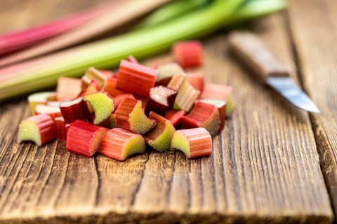 Chopped Rhubarb on an old wooden table (close up shot, selective focus)