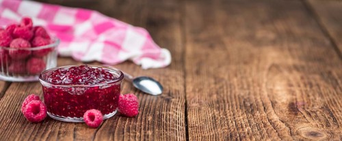 Some homemade Raspberry Jam as detailed close-up shot, selective focus