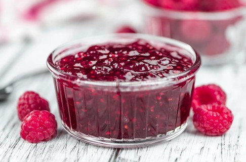 Some homemade Raspberry Jam as detailed close-up shot, selective focus