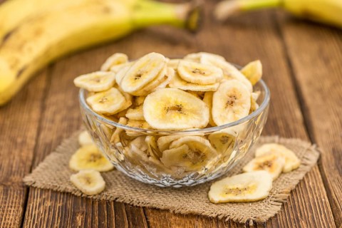 Fresh made Dried Banana Chips on an old and rustic wooden table, selective focus, close-up shot