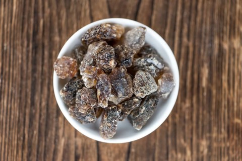 Brown Rock Candy on wooden background (selective focus, close-up shot)