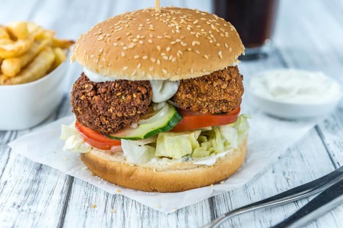 Homemade Falafel Burger (detailed close-up shot, selective focus) on a wooden table