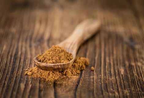 Fresh made Cinnamon Powder on a vintage background (close-up shot)