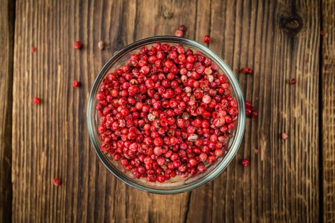 Pink Peppercorns on a vintage background as detailed close-up shot, selective focus