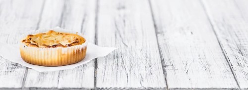 Fresh made Mini Cheesecake on an old and rustic wooden table (selective focus, close-up shot)