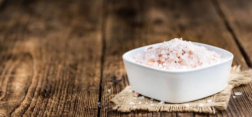 Himalayan Salt as high detailed close-up shot on a vintage wooden table (selective focus)