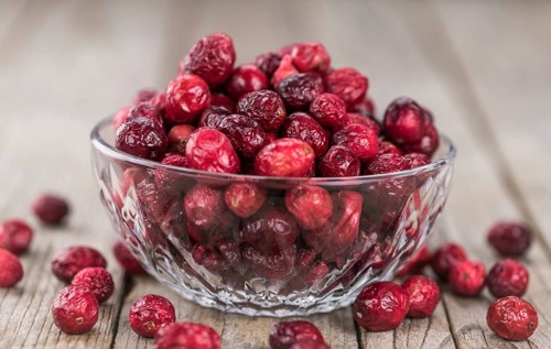 Dried Cranberries on an old wooden table (selective focus)