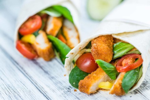 Fresh made Chicken Wraps on an vintage background (selective focus)