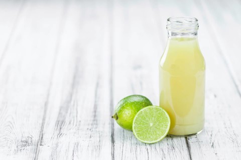 Portion of fresh Lime Juice (close-up shot, selective focus)