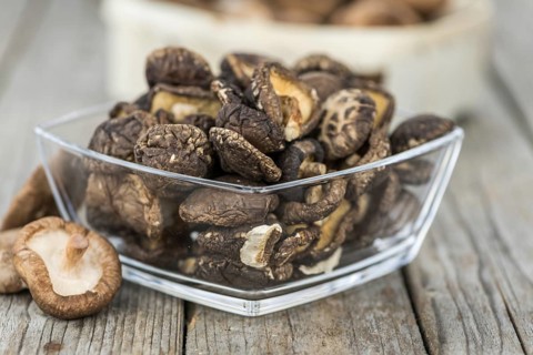 Homemade Dried Shiitake on an wooden table as detailed close-up shot, selective focus