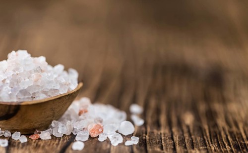 Pink Salt on a vintage background as detailed close-up shot (selective focus)