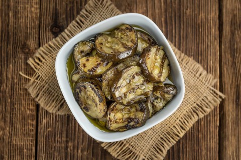 Homemade Antipasti (Grilled Zucchinis) on vintage background (selective focus, close-up shot)