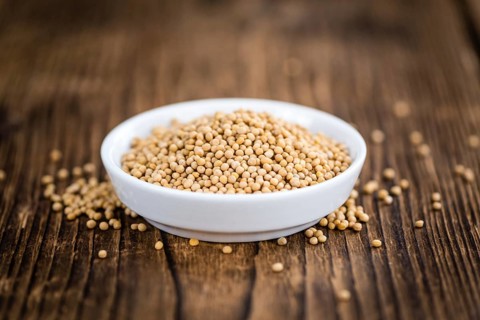 Mustard Seeds on a vintage background as detailed close-up shot (selective focus)