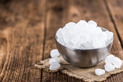 White Rock Candy on wooden background (detailed close-up shot, selective focus)