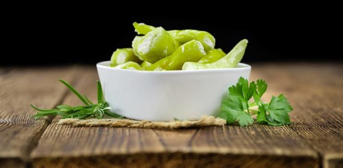 Fresh made Green Chilis (filled with cheese) on a vintage background (close-up shot)