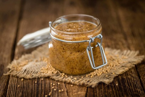 Fresh made German Cuisine (sweet Mustard) on a vintage background (close-up shot)
