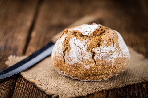 Fresh made Wholemeal Bun on a vintage background (close-up shot)