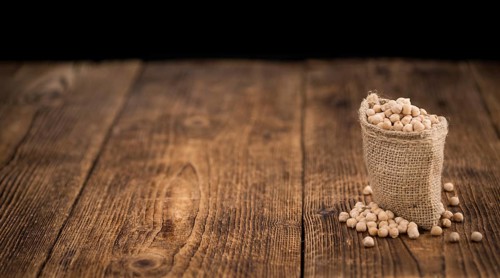 Chickpeas on a vintage background as detailed close-up shot, selective focus