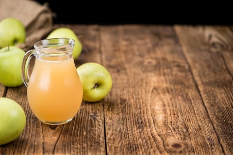 Fresh made Juice (apple) on a vintage background (close-up shot)
