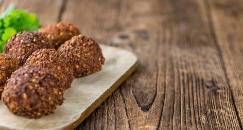Portion of Falafel on an old wooden table (close-up shot, selective focus)
