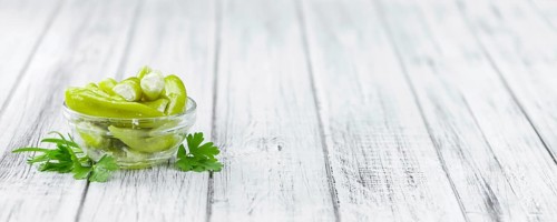Fresh made Green Chilis (filled with cheese) on a vintage background (close-up shot)