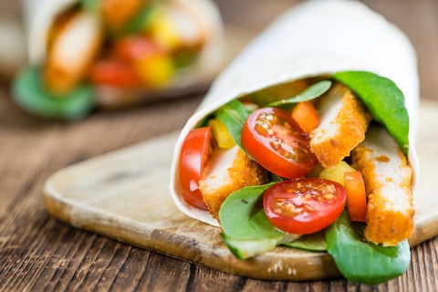 Fresh made Chicken Wraps on an vintage background (selective focus)