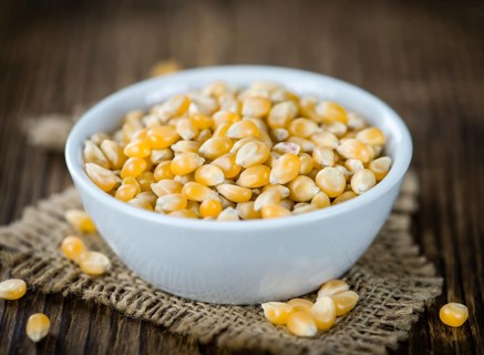 Portion of Corn (detailed close-up shot) on wooden background (selective focus)