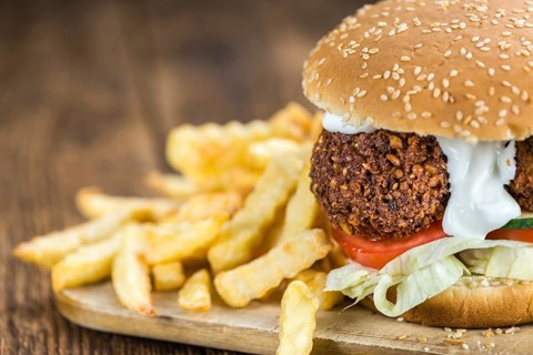 Fresh made Falafel Burger (close-up shot, selective focus) on wooden background