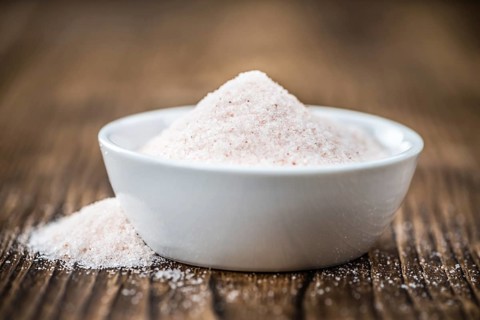 Pink Salt on a vintage background as detailed close-up shot (selective focus)