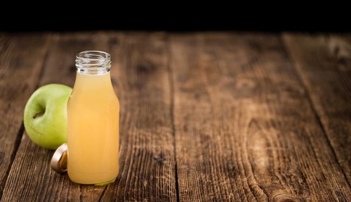 Fresh made Juice (apple) on a vintage background (close-up shot)