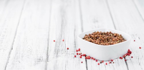 Portion of fresh preserved Pink Peppercorns close-up shot, selective focus
