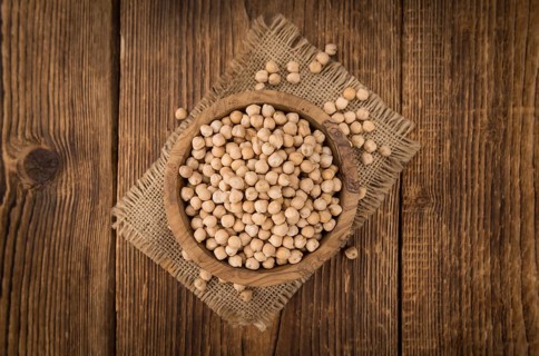 Dried Chickpeas as high detailed close-up shot on a vintage wooden table, selective focus