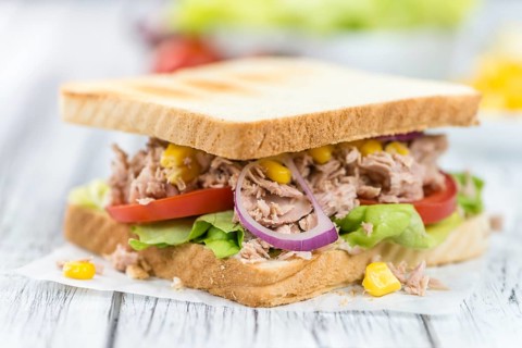 Homemade Tuna Sandwich (selective focus, close-up shot) on vintage wooden background