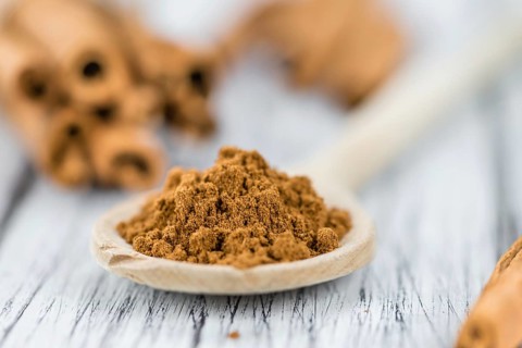 Fresh made Cinnamon Powder on a vintage background (close-up shot)