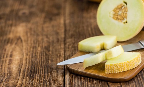 Fresh made Honeydew Melon on a vintage background (close-up shot)